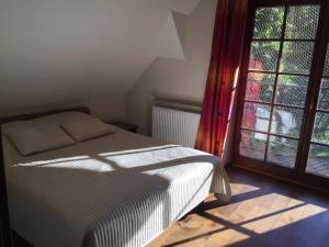 a bedroom with a bed and a large window at Apartamenty-Plaza Zakopane in Zakopane