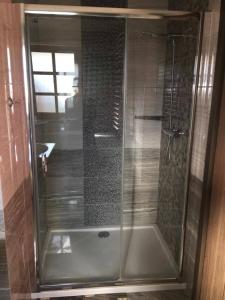 a shower with a glass door in a bathroom at Apartamenty-Plaza Zakopane in Zakopane +40 photos