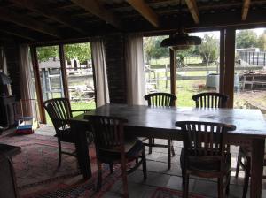 a dining room with a wooden table and chairs at Leuk vakantiehuisje 6p in Brunssum +13 photos