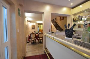 a kitchen with a counter and a dining room at Hotel Genova in La Spezia