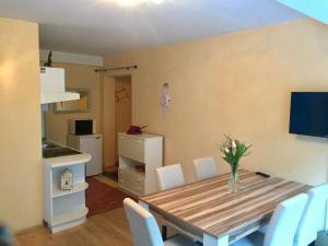 a kitchen and dining room with a table and chairs at Apartment "Herbert" Sonnleitn/Nassfeld in Sonnenalpe Nassfeld