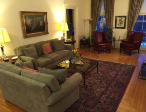a living room with a couch and a table and chairs at Blackinton Manor in North Adams