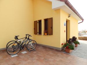 a bike parked on the side of a building at Apartments Oltari in Sveti Juraj