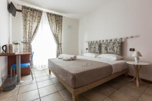 Postel nebo postele na pokoji v ubytování Le Campane di Assisi + 21 fotografií