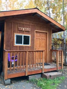 a shed with a porch and a door at Sven's Basecamp Hostel in Fairbanks