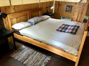 a wooden bed in a room with at Sven's Basecamp Hostel in Fairbanks