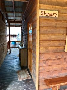 a wooden cabin with a sign on the wall at Sven's Basecamp Hostel in Fairbanks