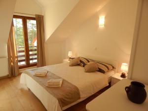 a bedroom with a bed with two towels on it at Apartments Oltari in Sveti Juraj +49 photos