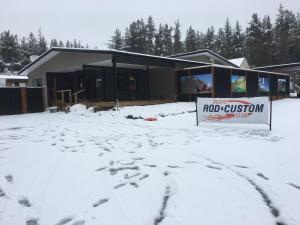 a building in the snow with a sign in front of it at Tongariro Holiday Park in Tongariro +30 photos
