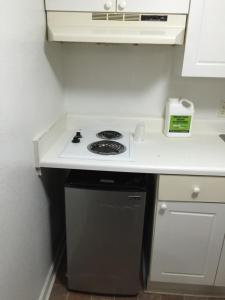a kitchen with a stove and a counter top at Extended Stay Studios in Montgomery
