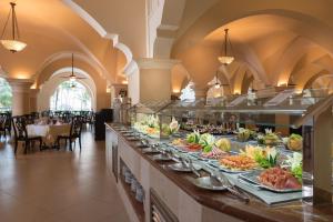 a buffet line with many plates of food at Occidental Caribe - All Inclusive in Punta Cana