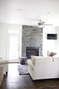 uma sala de estar com um sofá branco e uma lareira em Stonehill Cottages em Mena