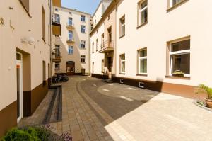 an empty alley between buildings in a city at Fantasia Apartments in Krakow