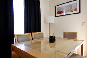 a dining room table with chairs and a lamp at Cape Jervis Holiday Units in Cape Jervis