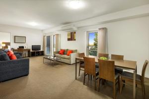 a living room with a couch and a table and chairs at Quest Mildura in Mildura