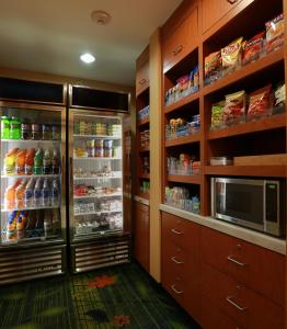 a kitchen with a refrigerator and a microwave at Fairfield Inn and Suites by Marriott Marion in Marion