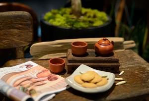 a table with a plate of cookies and cups on it at Lakeview Homestay in Yuchi