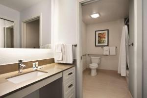 a bathroom with a sink and a toilet at Hyatt House Pleasant Hill in Pleasant Hill