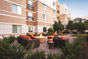 a courtyard with chairs and a fire pit in front of a building at Hyatt House Pleasant Hill in Pleasant Hill