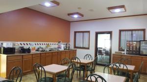 a restaurant with tables and chairs and a counter at Americas Best Value Inn and Suites - Nevada in Nevada
