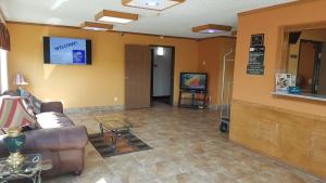 a waiting room with a couch and a tv at Americas Best Value Inn and Suites - Nevada in Nevada