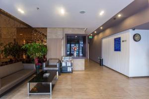 a lobby with a couch and a table in a building at Jinjiang Inn Beijing Gucheng North Road in Beijing