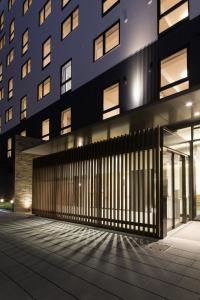 a building with a gate in front of it at Karaksa Hotel Osaka Namba in Osaka