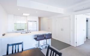 a kitchen with a sink and a table at Eastwood Apartments in Brisbane