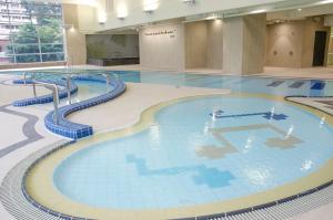 a large swimming pool in a building at The Salisbury - YMCA of Hong Kong in Hong Kong