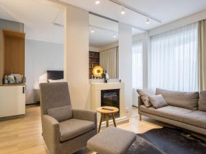 a living room with a couch and chairs and a fireplace at Original Sokos Hotel Kaarle Kokkola in Kokkola