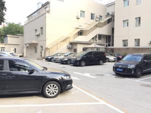 a parking lot with many cars parked in it at Jinjiang Inn Beijing South Railway Station in Beijing