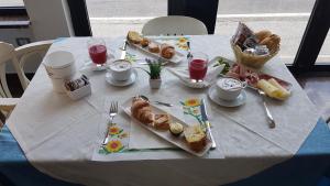 a white table with food and drinks on it at Perticari in Pesaro