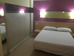 Postel nebo postele na pokoji v ubytování Hostal Ducal