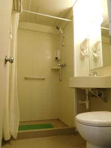 a bathroom with a shower and a toilet and a sink at Jinjiang Inn Beijing Liangxiang Nanguan Subway Station in Fangshan +21 photos