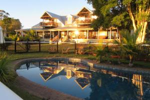 a house with a swimming pool in front of it at Clarence River Bed & Breakfast in Grafton
