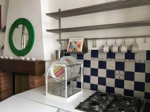 a kitchen with a sink and a stove and a mirror at Maison Lodi in Milan