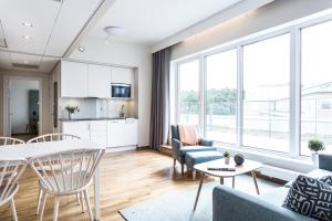 a living room with a table and chairs at Biz Apartment Hammarby Sjöstad in Stockholm