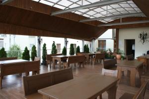 a restaurant with tables and chairs and windows at Noclegi Nad Osławą in Zagórz