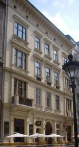a large white building with windows and a street light at Danube Bridge Apartments in Budapest