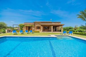 a villa with a swimming pool in front of a house at Ca Na Francisca in Alcudia