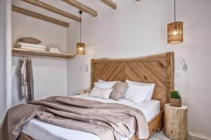 
a bedroom with a bed and a lamp at Orkos Beach Hotel in Mikri Vigla
