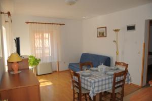 a living room with a table and a blue chair at Villa Radovan in Novigrad Istria +18 photos