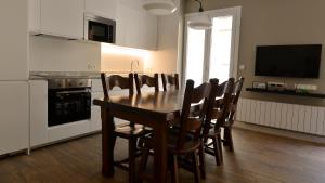 a dining room with a wooden table and chairs at Tabakalera, San Sebastián. in San Sebastián