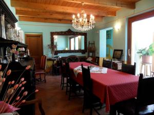 a dining room with a red table and chairs at Cascina Gardina in Castellero