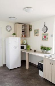 a kitchen with a white refrigerator and a counter at Smart2Stay U Jakuba in Warsaw