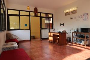 a living room with a table and a desk at Hotel Celi in Calangute