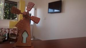 a wooden sculpture of a windmill in a living room at Costa Aguacates in Posadas