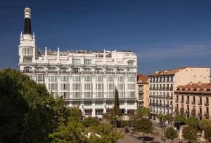 a large white building with a tower on top of it at ME Madrid Reina Victoria by Meliá in Madrid