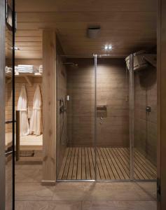 a walk in shower with a glass door in a bathroom at Selfish Club in Kiylov