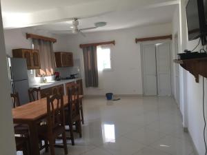 a kitchen and dining room with a table and chairs at Villa Violette in Ambatoloaka
